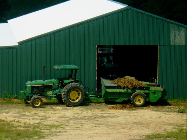 small farm tractor and manure spreader