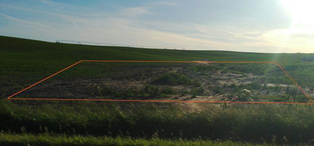 a former location of a beef feedlot pen. The location received run on from the field above and runoff from the lot was uncontrolled. It was relocated.